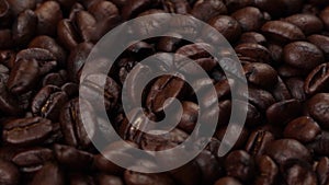 Slow motion roasted coffee beans falling down and rotating