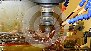 Slow motion scene the hole making by peck drilling cycle process on CNC milling machine with liquid coolant method