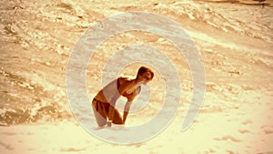 Slow motion sea wave girl. Vintage sepia old film effect