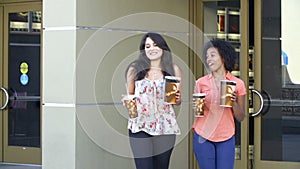 Slow Motion Sequence Of Two Female Friends Outside Cinema