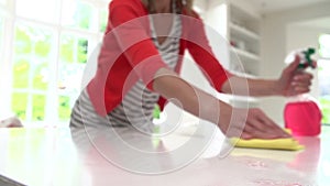 Slow Motion Sequence Of Woman Cleaning Surface In Kitchen