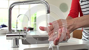 Slow Motion Sequence Of Woman Washing Hands In Kitchen Sink