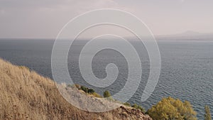 Slow motion of Sevan lake in October on a hazy day