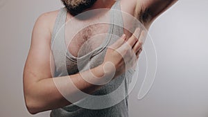 Slow motion shoot of strong man rising his arms, showing biceps and hairy armpits and showing thumb up. Refusal of depilation or s