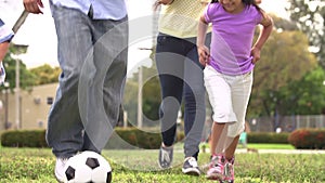 Slow Motion Shot Of Hispanic Family Playing Soccer Together