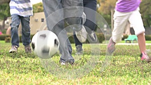 Slow Motion Shot Of Hispanic Family Playing Soccer Together