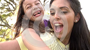 Slow Motion Shot Of Mother Giving Daughter Piggyback Ride