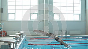 Slow-Motion shot of Professional concentrated female swimmer on starting block.