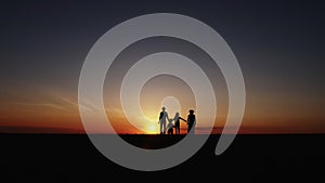Slow Motion Silhouette at sunset happy family walking