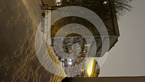 Slow motion of snowing at night. Weather forecast. Falling snow in residential area at night. City courtyard night view