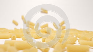 SLOW MOTION: Stream of tortiglioni pasta moving to a camera