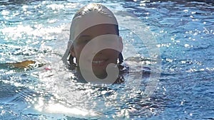 Slow motion of summer season girl in swimming in pool