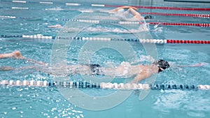 Slow motion swimmer competition or training at swimming pool