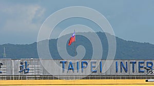 Slow motion taiwanese flag waving in wind at Taipei internatinal airport.