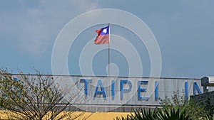 Slow motion taiwanese flag waving in wind at Taipei internatinal airport.