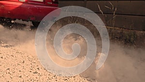 Slow motion tires on gravel of race car