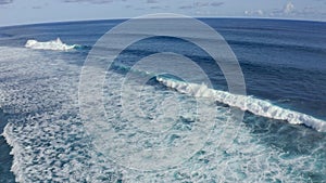 Slow motion top down aerial view of the ocean giant waves, foaming and splashing