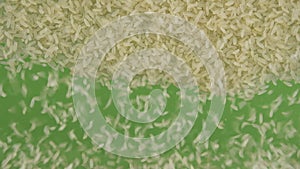 Slow motion. Top view on flying and falling rice grains. The seeds fall and fill the green screen. Top view