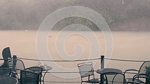 Slow motion: A torrential downpour pours into the lake in central park, NYC