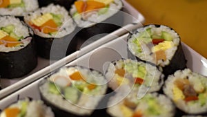 Slow Motion traditional rolled sushi Japanese food in restaurant. Nori roll.