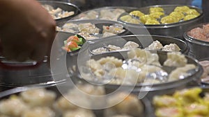 Slow motion Vendor selling Dumpling and Shaomai in Asian Street Food Market