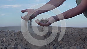 Slow motion video of Human`s hands hold earth dust. Drought, land without rain