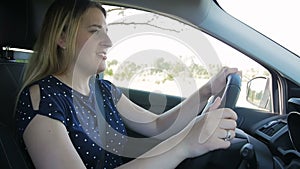 Slow motion video of mad angry female driver shouting and screaming while driving a car