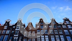 Slow motion video of view from the canal to the streets, canals with old flamish houses and bridges in Amsterdam