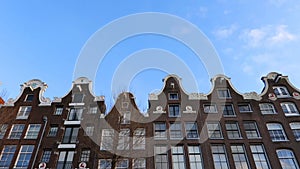 Slow motion video of view from the canal to the streets, canals with old flamish houses and bridges in Amsterdam