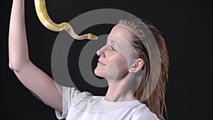 Slow motion video of woman putting up albino python
