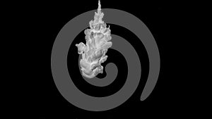 Slow motion of white acrylic paint swirling underwater on black background