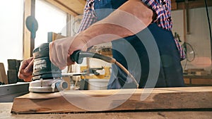 Slow motion of a wooden board getting buffed