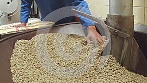 Slow motion of workers hands distributing coffee beans