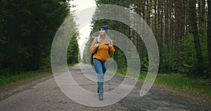 Slow motion: Young woman hiking in forest. Hiker camping in woods. Tourist walking along the river. 4K video shooting by