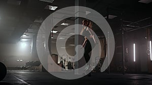 Slow motion: Young woman skipping rope. woman jump roping in the gym as part of her workout routine, determined woman