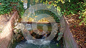 Slow movement of water in stream flowing into waterfall