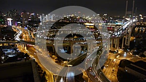 Slow moving cars on overpass interchange,Brightly lit urban building,shanghai.