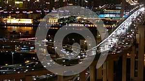 Slow moving cars on overpass interchange,Brightly lit urban building,shanghai.