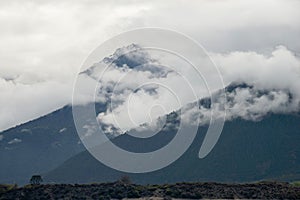 Slow moving clouds over the pine forest covered mountains