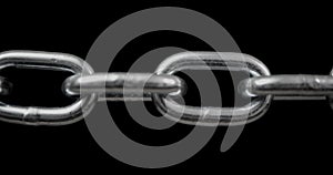 Slow panning across a shiny steel chain showing each link pulled taut. Concept of strength, security, or strong connection