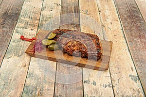 Slow-roasted piece of beef with barbecue sauce, pickled gherkins