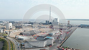 Slow rotation birds eye over the Esbjerg harbor and the Steelcon chimney of the coal fired power station. This chimney