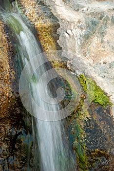 Slow shutter small waterfall on rocks, Oman