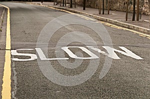 Slow sign on a bend in Edinburgh road, UK