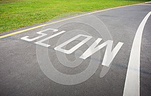 Slow sign painted on the road