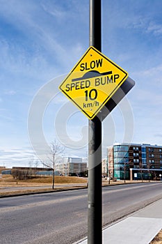 Slow Speed Bump Road Sign on Residential Street