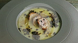 Slow zoom in at exquisite decorated tasty onion cream soup with sausage slices