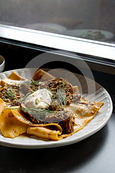 Slowly Braised Lamb Ragu on a white plate