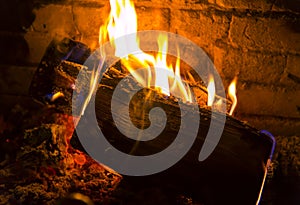 Slowly burning firewoods in a fireplace