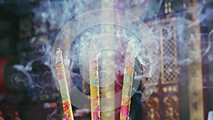 Slowly burning incense sticks in Chinese Buddhist temple